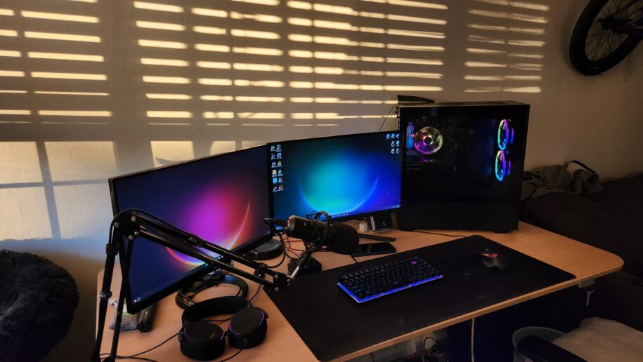 Gaming PC setup with two monitors to the left of the desktop.